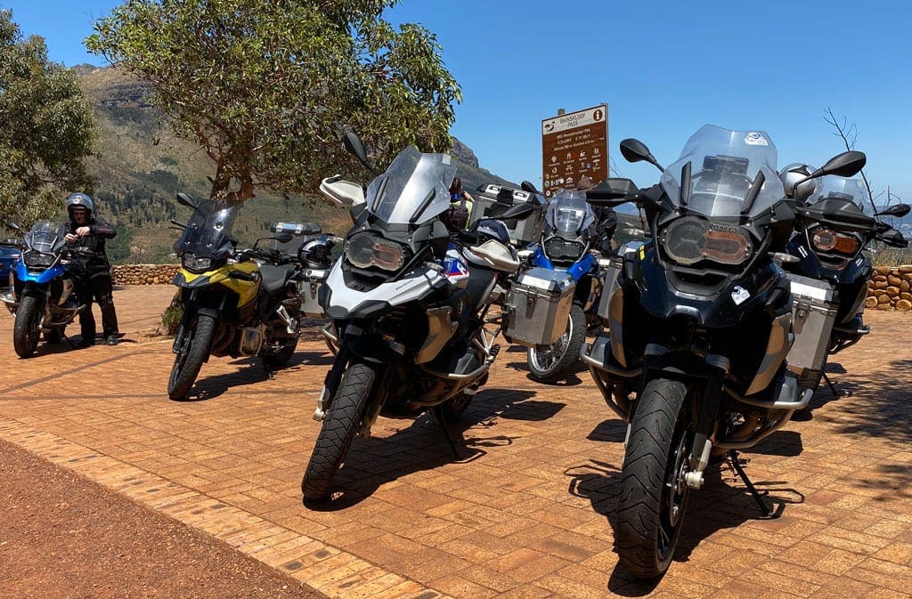Leaving the city 2 A group of motorbikes parked on a roadside.