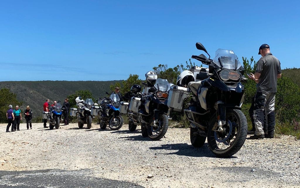 The group are parked up on the side of a gravel road.