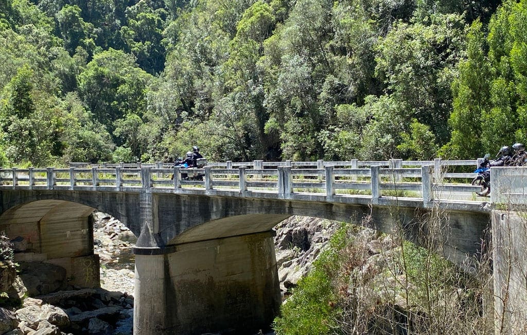 The group cross over a bridge.