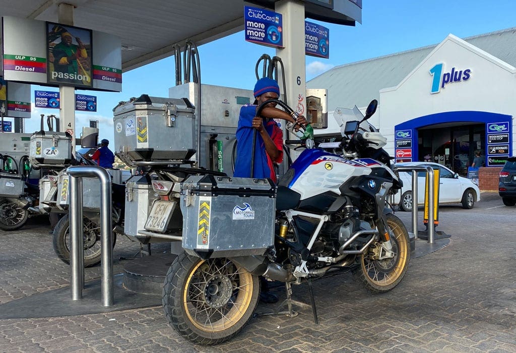 All the way 5 A man fills up one of the bikes with gas.