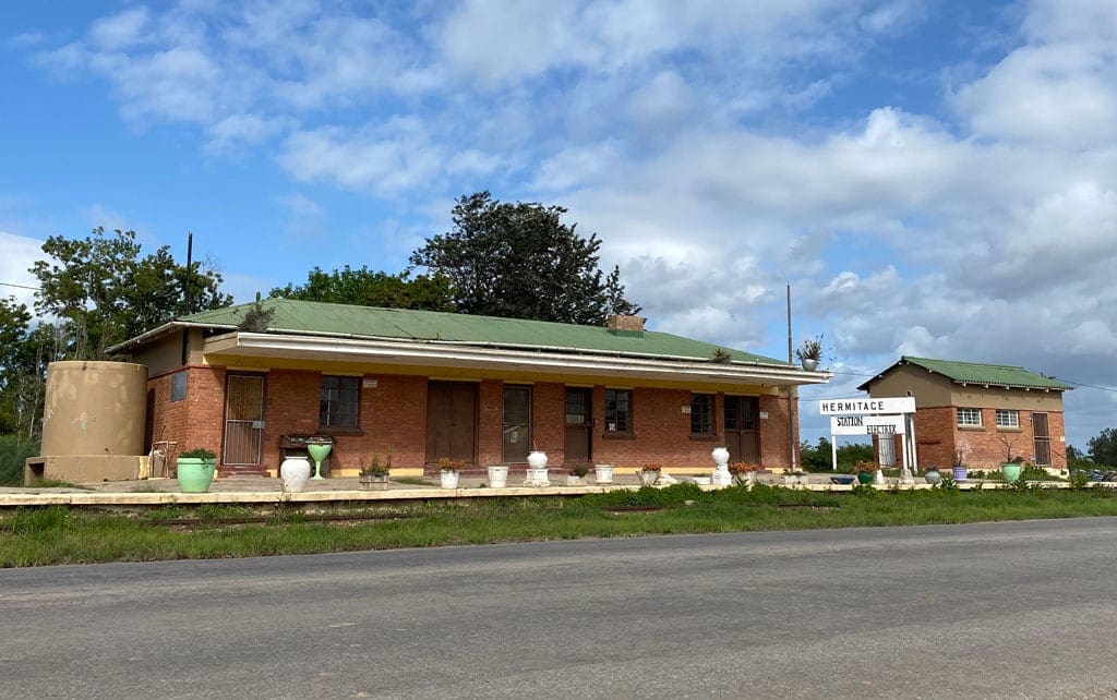 All the way 4 A pair of small, seemingly closed buildings on the side of the road.