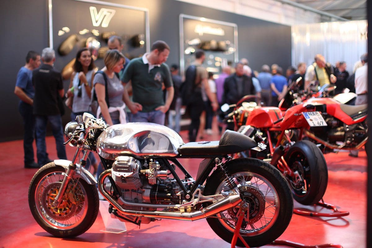 People in the background looking at motorbikes on display