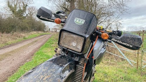 TRF sticker on front of a muddy road bike off-road
